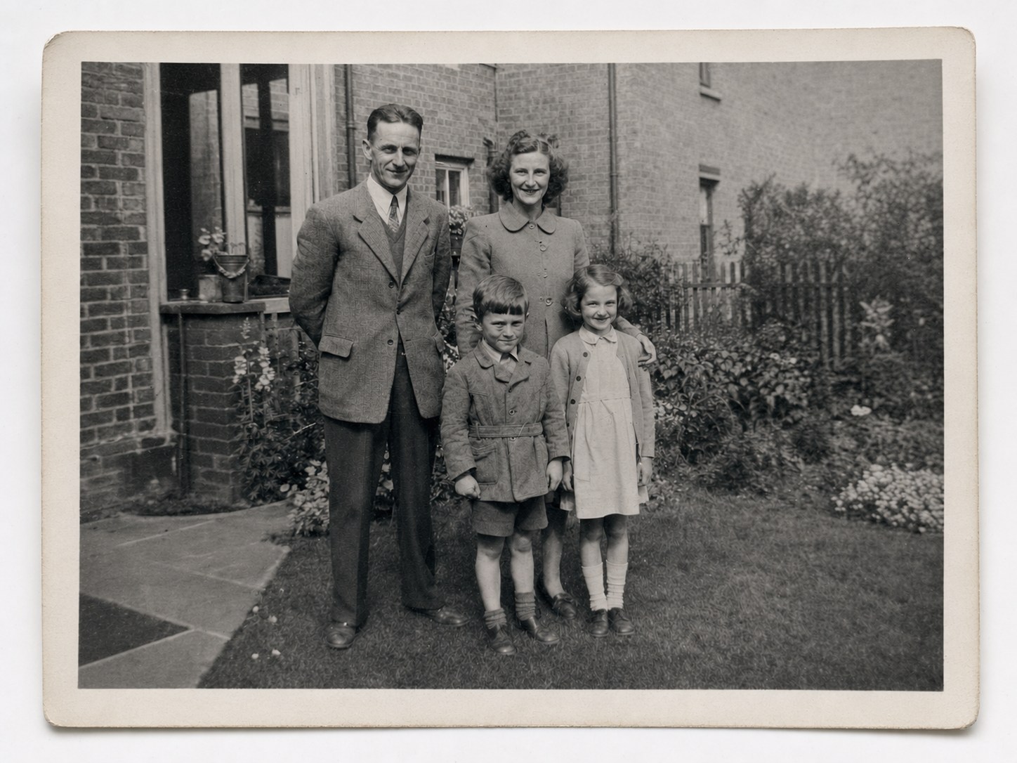 Generated demonstration of the same black-and-white family photograph after careful digital restoration.